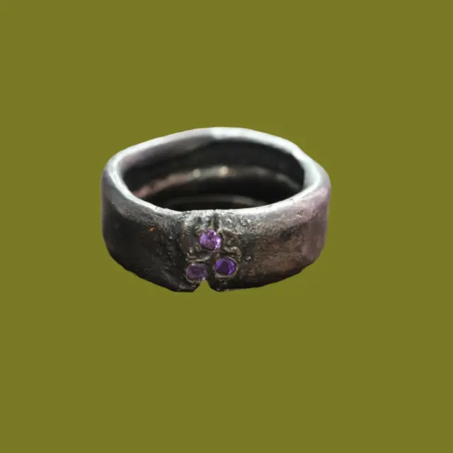 Ember
An ode to inner strength

This bold ring, named Ember, is a powerful statement for those who dare to be unapologetically themselves. Crafted from oxidized silver, Ember carries the raw beauty of life — rugged, intense, and honest.

With its solid, wide band, it feels substantial on the finger — a tangible symbol of resilience and individuality. Set into the silver are three carefully selected amethysts, each with its own subtle glow. These gemstones represent protection, spiritual depth, and inner peace.